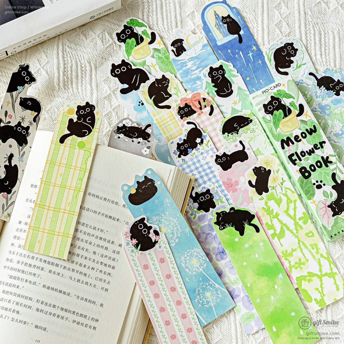 Cute black cat sticky bookmarks peeking from a book – floral plant theme