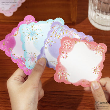 Colorful scalloped note cards in pink blue and purple with gold foil fireworks and star accents held in hand