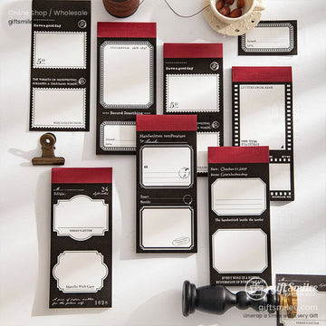 Vintage-style black and red sticky notes and memo pads set for journaling and scrapbooking on desk flat lay