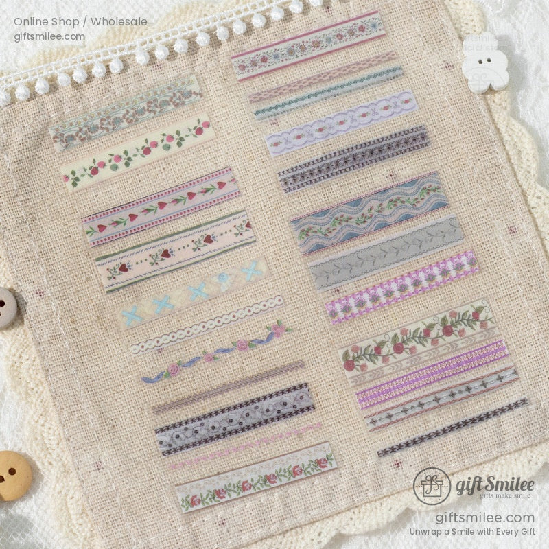 Flat lay of vintage floral washi tape and stickers on lace fabric with pearls