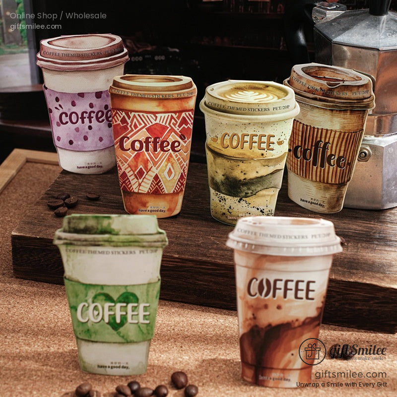 Six artistic coffee cup stickers with various vibrant designs on a rustic wooden table.