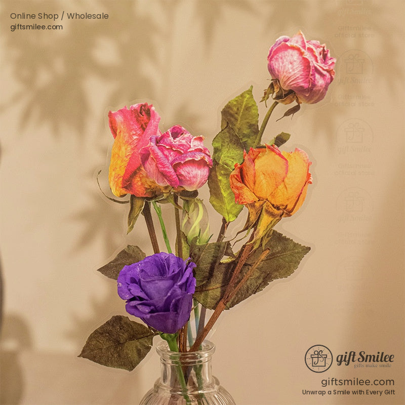 Hands arranging pressed rose stickers with lace ribbon on an open book