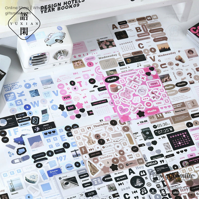 A collection of Collage Freedom sticker books in blue, pink, brown, and black themes displayed on a desk