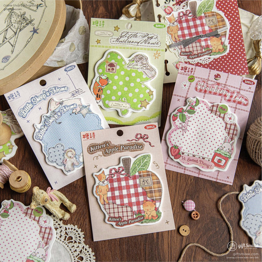A cozy collection of Cottagecore scrapbook stickers featuring a mix of animal designs like kittens, sheep, and woodland creatures, displayed on a rustic wooden table