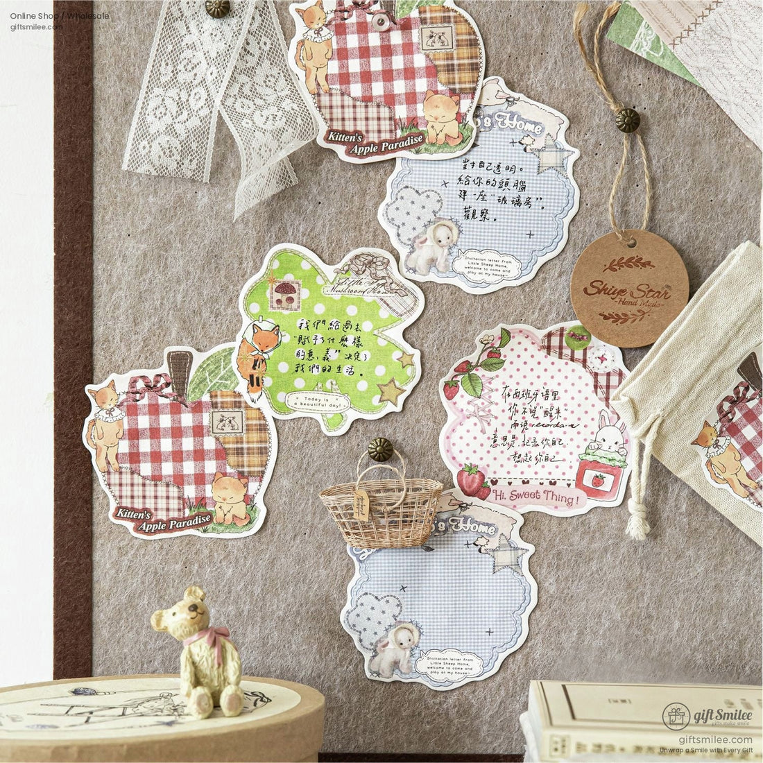 A cozy collection of Cottagecore scrapbook stickers featuring a mix of animal designs like kittens, sheep, and woodland creatures, displayed on a rustic wooden table