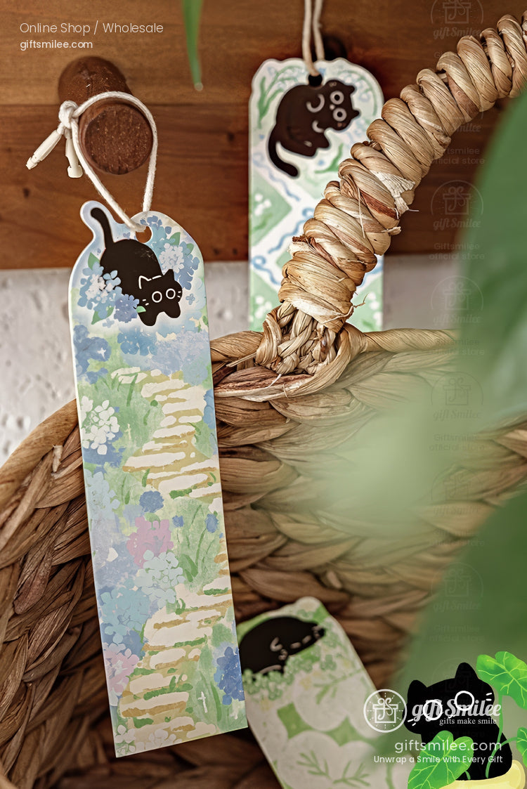 Cute black cat bookmark with watercolor garden path design hanging on wicker basket