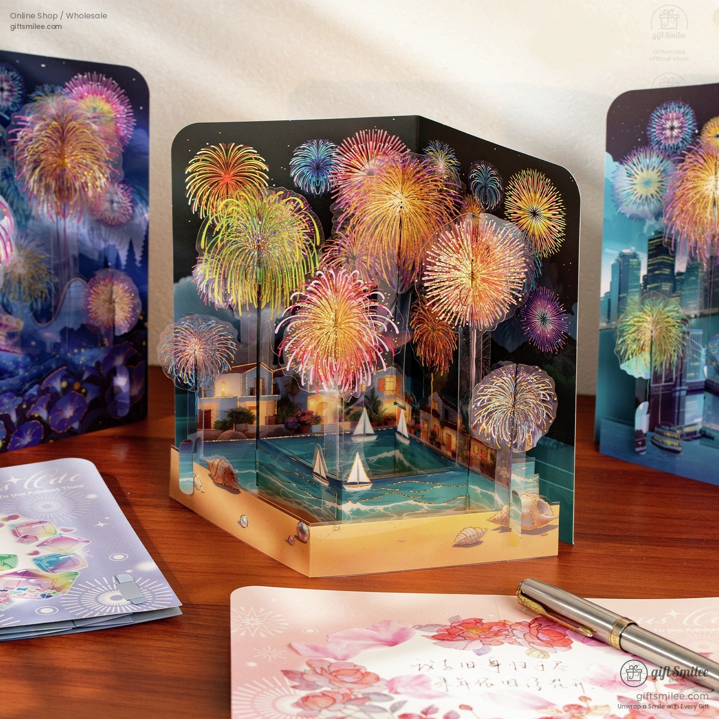 Multicolor 3D popup card with vibrant fireworks over a coastal village sailboats and decorative seashells