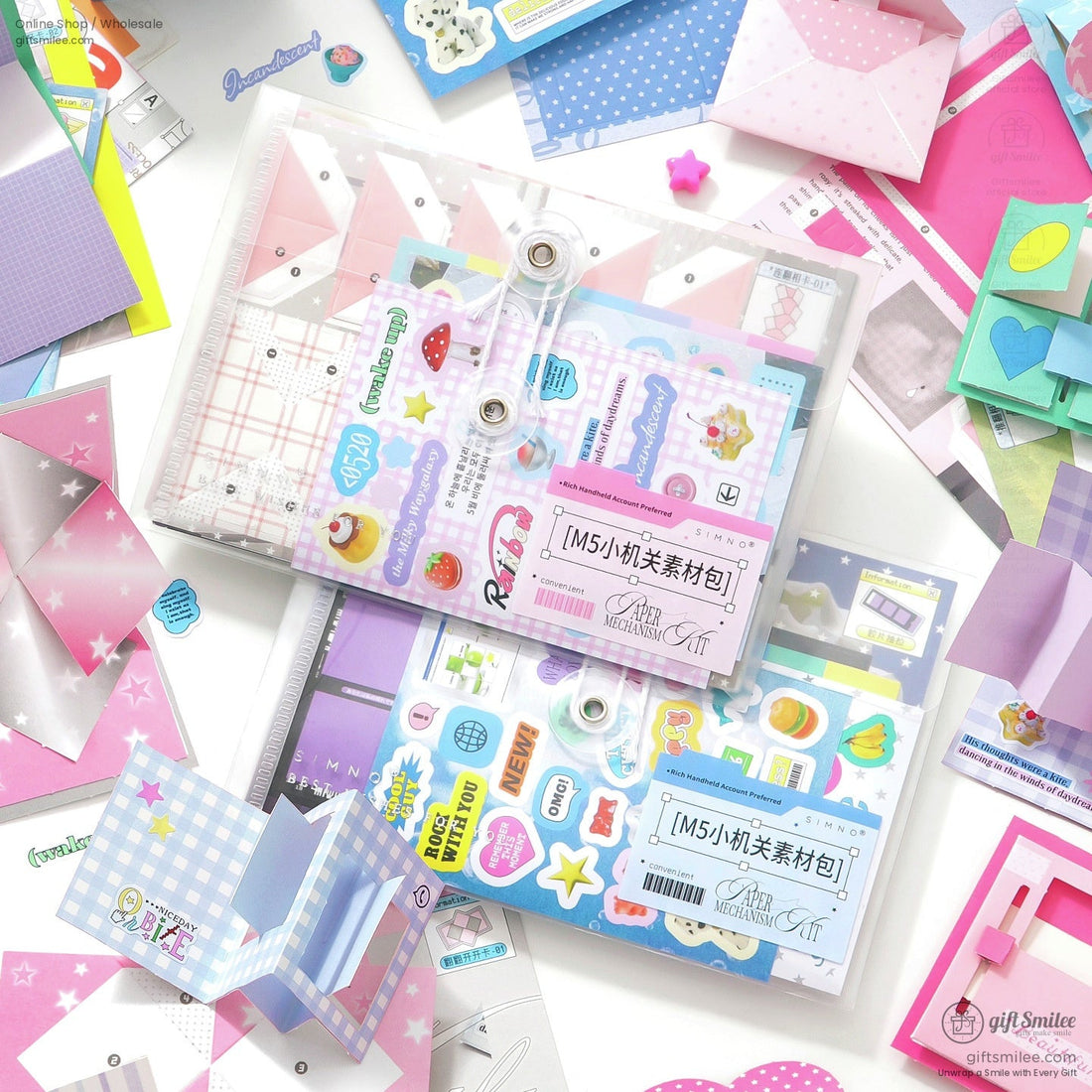 Colorful DIY scrapbook kit with stickers, papers, and envelopes laid out on a desk  