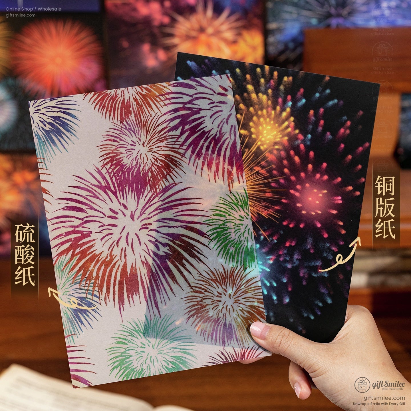 Fireworks-themed wrapping paper sheets showing matte and glossy finishes held by hand  