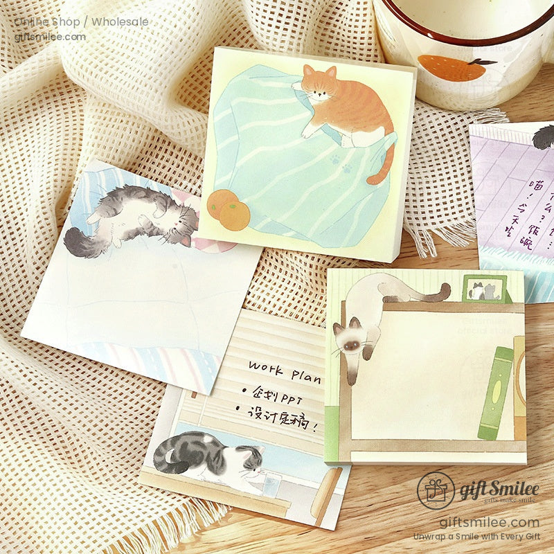 Illustrated sticky notes with playful cat designs pasteltoned backdrops and cozy details on a textured fabric
