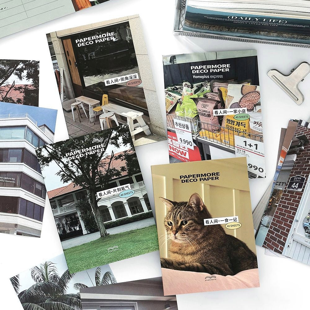 Assorted decorative paper sheets with urban and natural photography including a tabby cat architecture and greenery