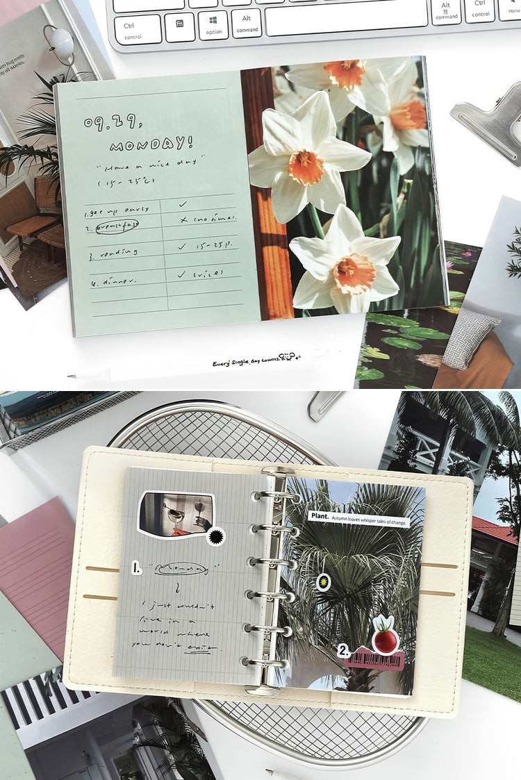Open beige leather planner with metal rings handwritten notes floral photos and tropicalthemed inserts on a white desk