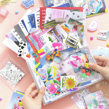 Colorful stationery set with vibrant stickers postcards holographic sheets and playful designs on a light peach desk