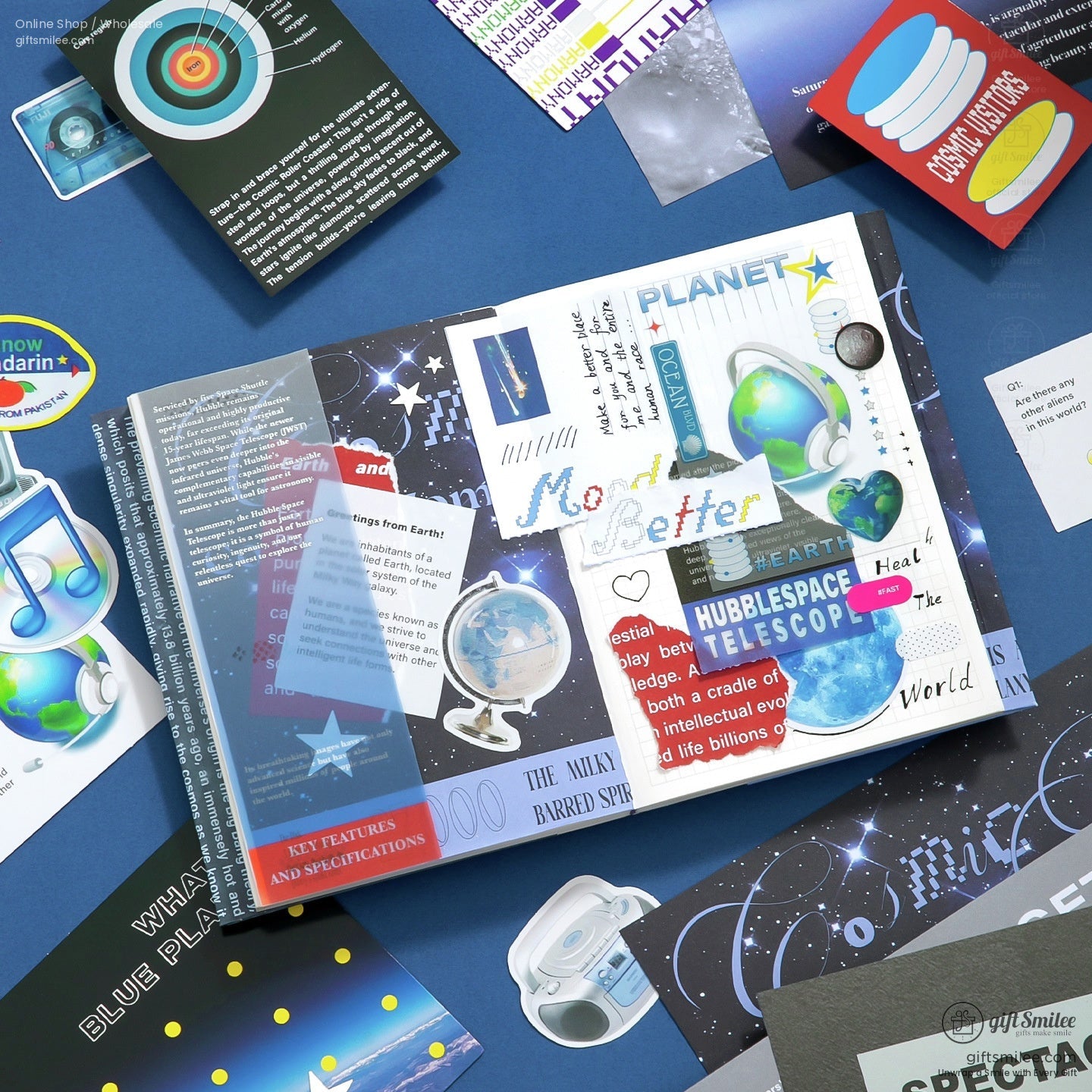 Open bluethemed educational book with space illustrations colorful planetary stickers and a small globe cutout