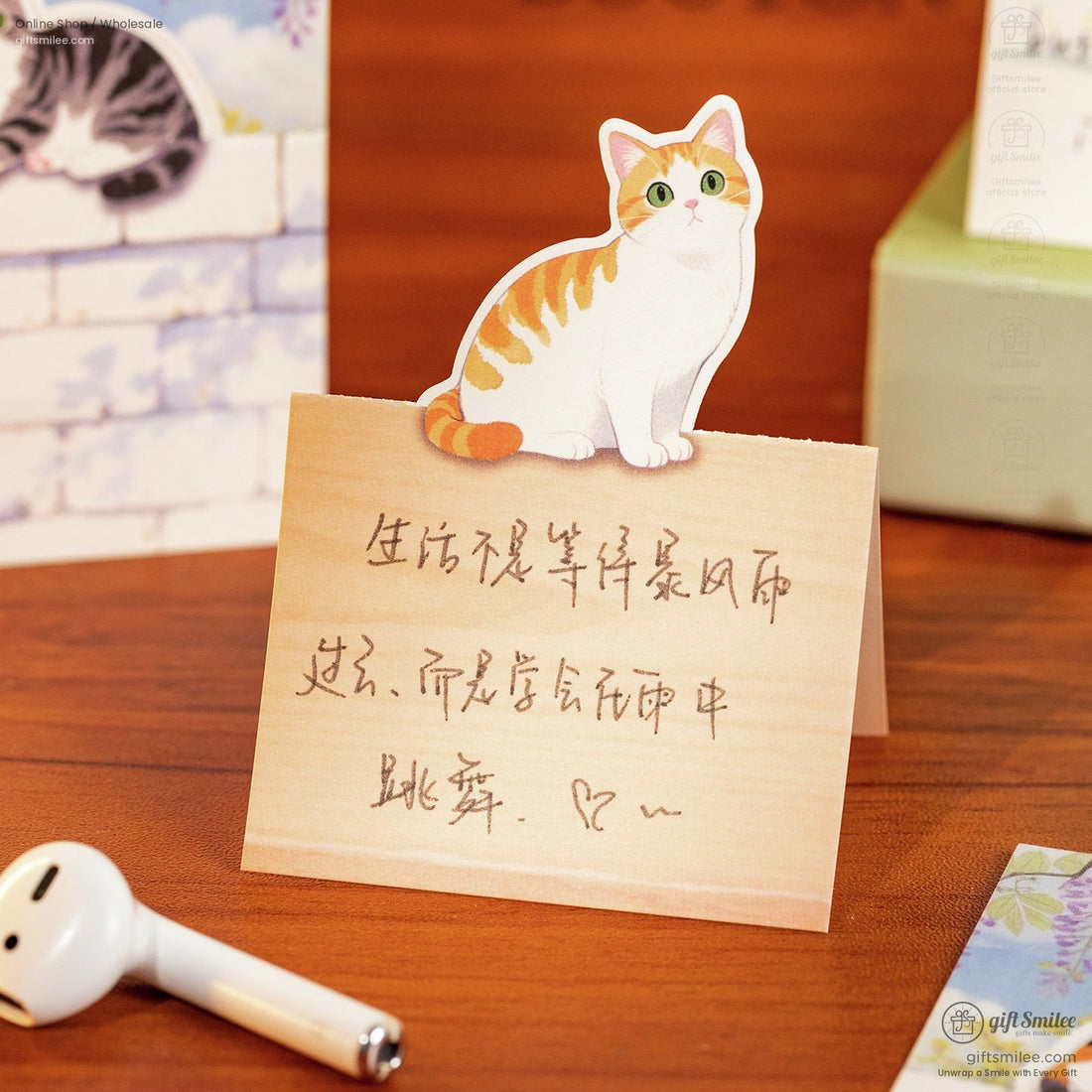 Decorative catthemed sticky notes in pastel designs featuring playful kittens against wood and floral backgrounds