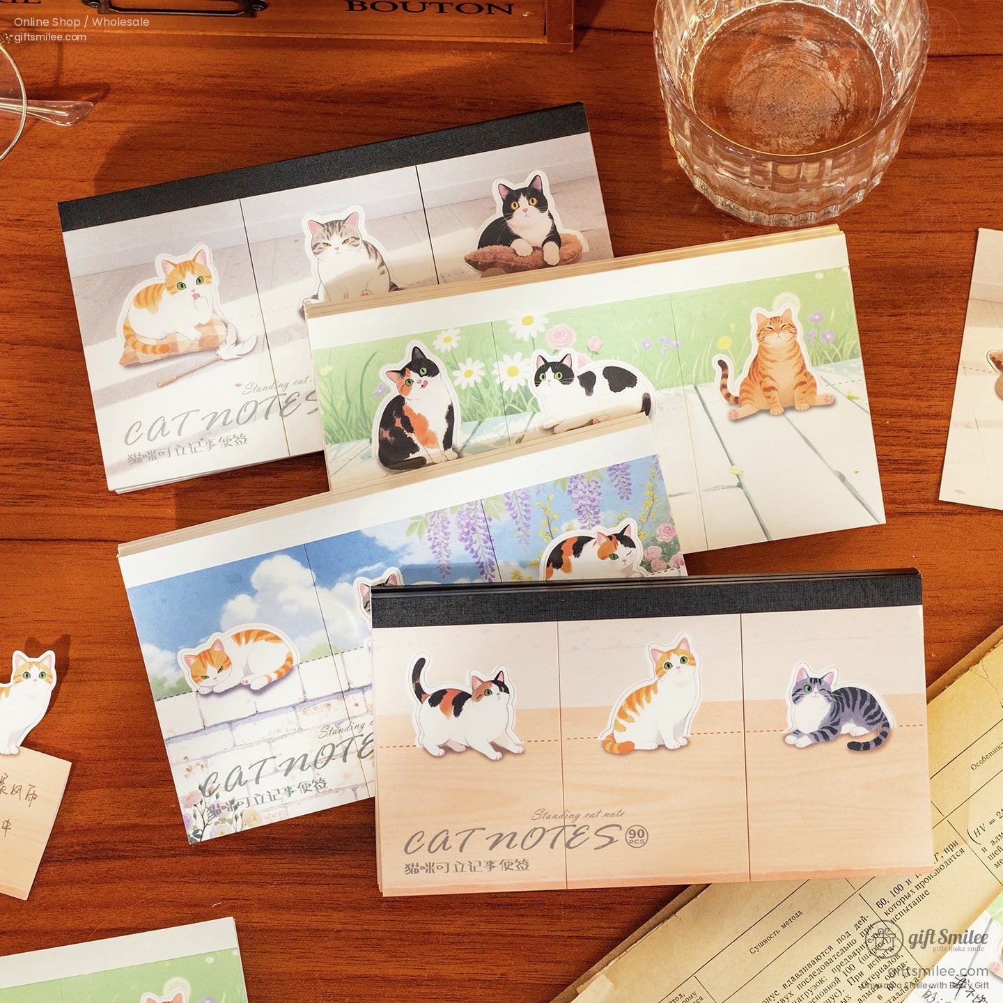 Assorted catthemed sticky note pads with colorful illustrations of adorable cats on wood floral and sky backgrounds