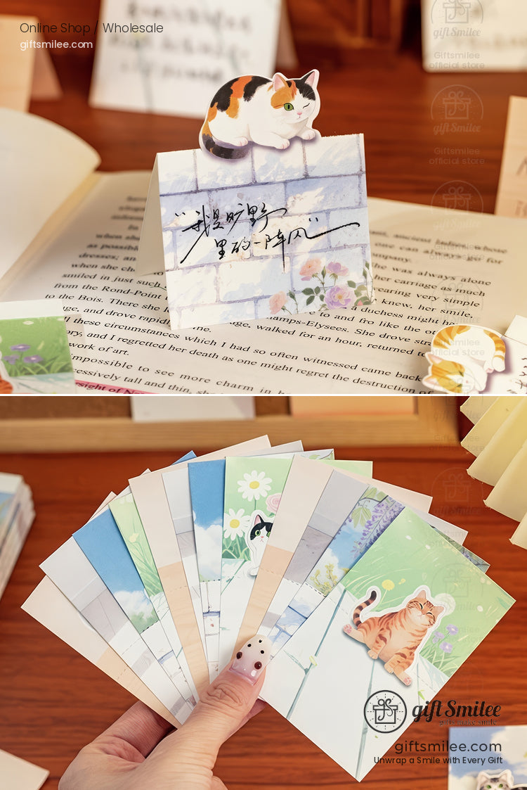 Handheld pastel catthemed bookmarks with floral designs featuring calico and tabby illustrations on sturdy cardstock