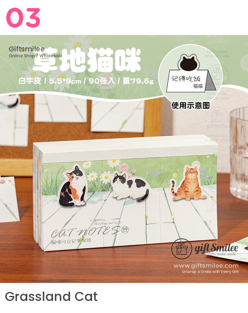 Pasteltoned catshaped sticky notes with floral background featuring calico tabby and blackandwhite cat designs