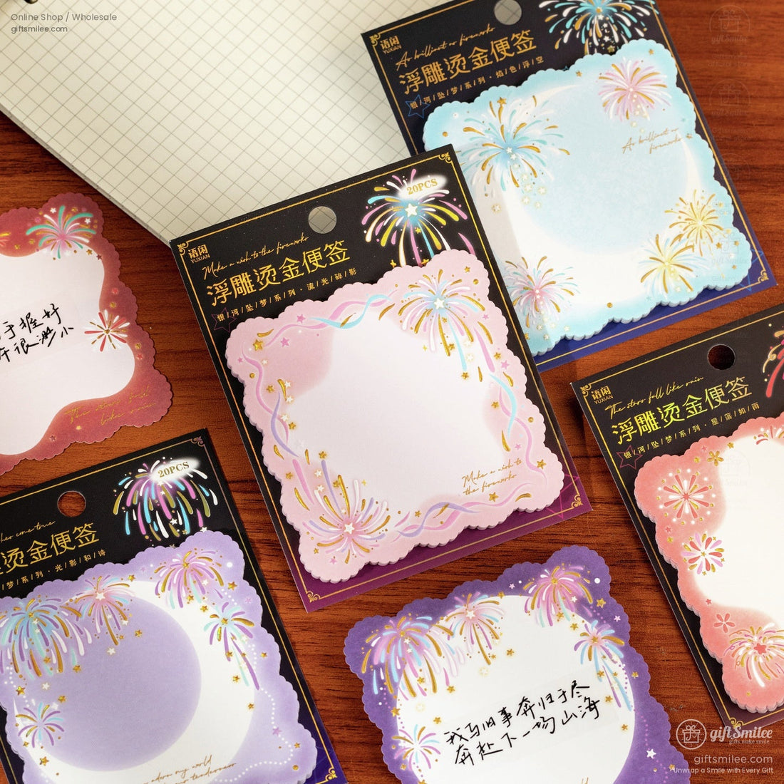 Colorful scalloped note cards in pink blue and purple with gold foil fireworks and star accents held in hand