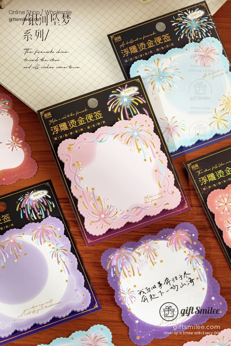 Scallopededge pastel sticky notes with gold foil fireworks design in purple pink and blue tones set on a wooden desk