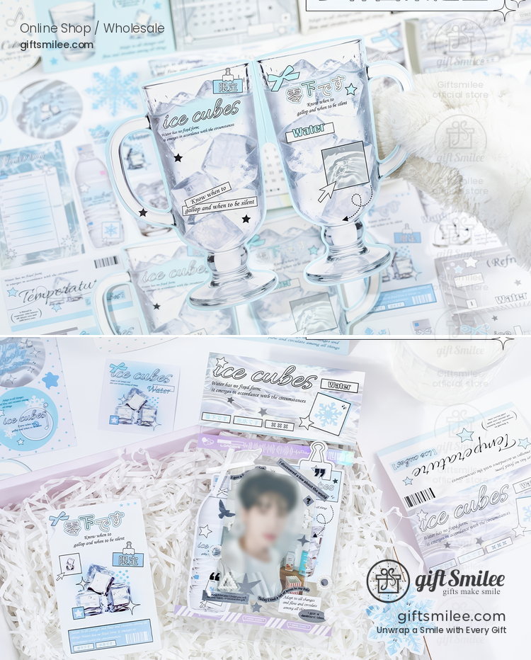 Clear glass mugs with ice cube patterns blue accents and frosted lettering surrounded by pastel stationery and decor