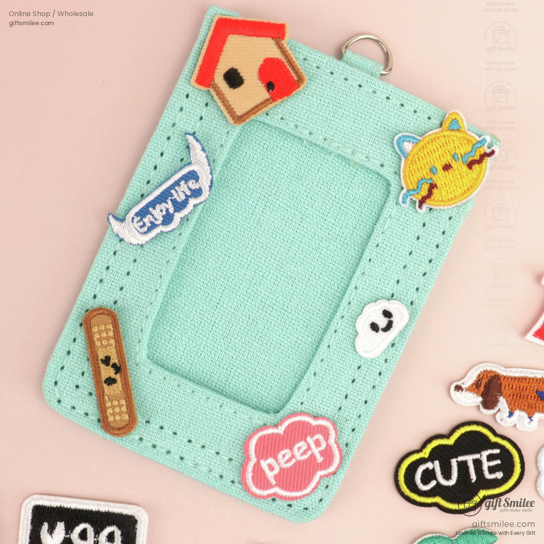 Colorful embroidered patches and keychain featuring playful shapes icons text and designs on a pastel background