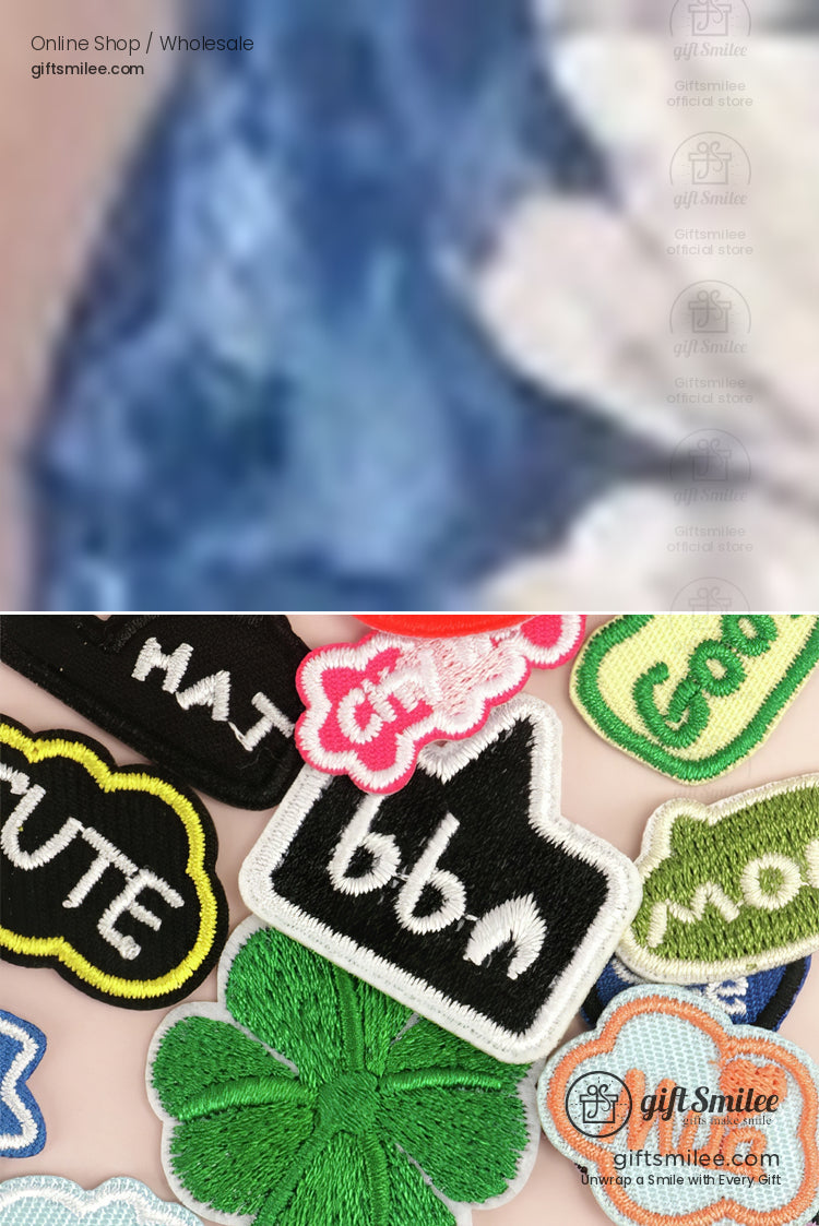 Assorted multicolored embroidered fabric patches including clovers clouds text labels and thumbsup designs