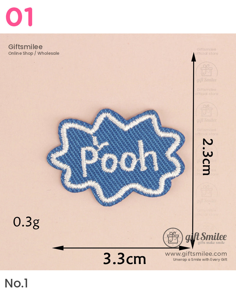 Blue embroidered patch with white Pooh text starburst design and outlined edges measuring 33cm by 23cm