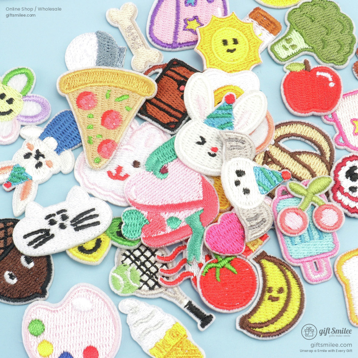 Colorful embroidered ironon patches with designs like pizza bunny sun fruits and more on a light blue background
