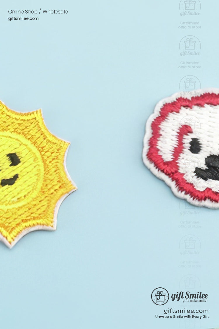 Yellow embroidered smiling sun patch and redoutlined white dog face patch on a pastel blue background
