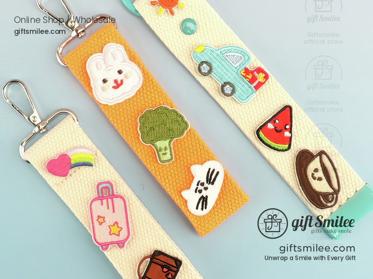 Colorful embroidered keychain straps with bunny broccoli watermelon and coffee cup designs on pastel backgrounds