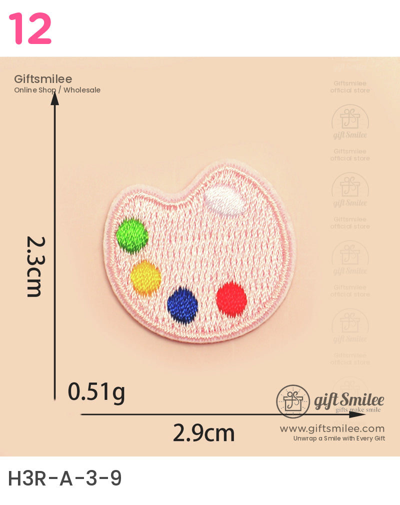 Pink embroidered paletteshaped patch with green yellow blue and red thread accents small and lightweight