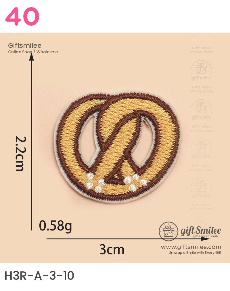 Golden brown embroidered pretzel patch with white salt accents 3cm wide lightweight at 058g playful design
