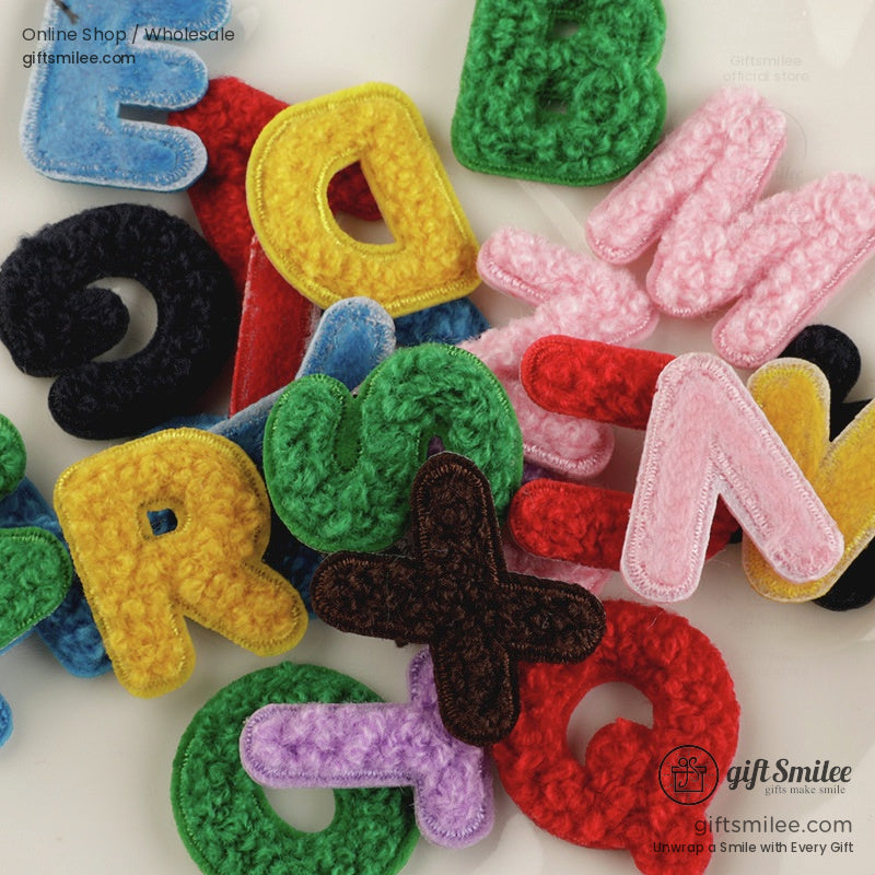 Multicolored chenille alphabet patches in vibrant red green yellow blue pink and purple with soft textured finish