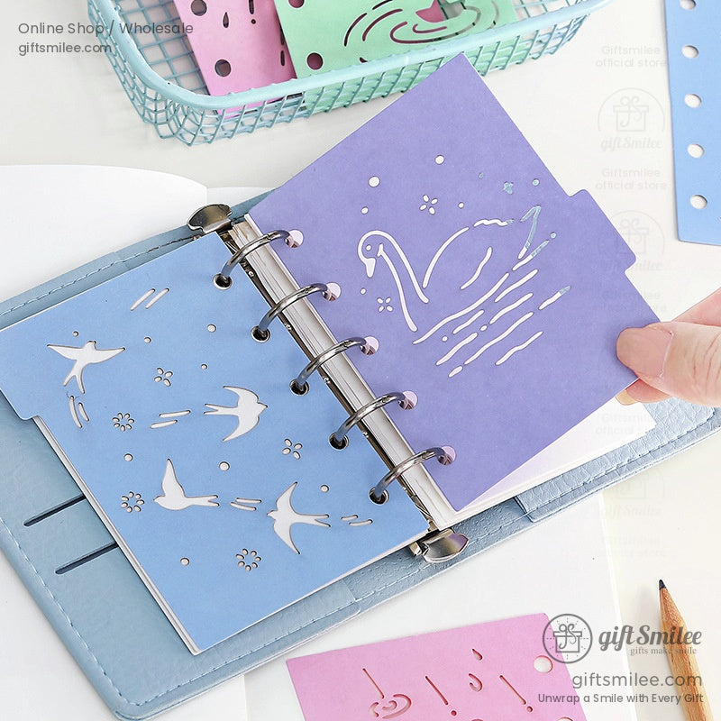 Open planner showcasing colorful divider inserts with nautical and umbrella-themed designs