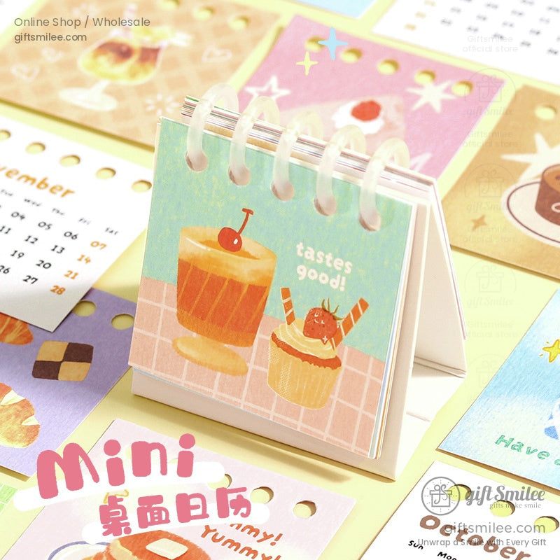 Mini desktop calendar featuring cute dessert illustrations with spiral binding for desk use