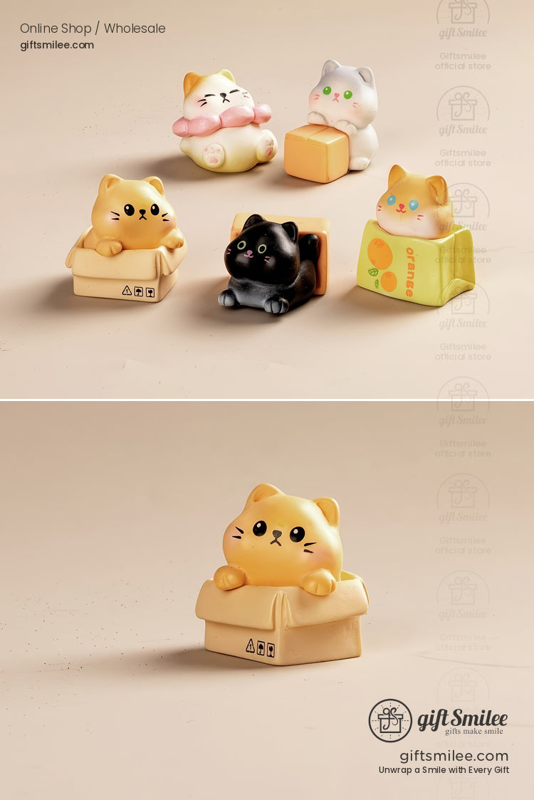 Colorful resin cat figurines in playful poses featuring boxes flowers and cartons on a beige background
