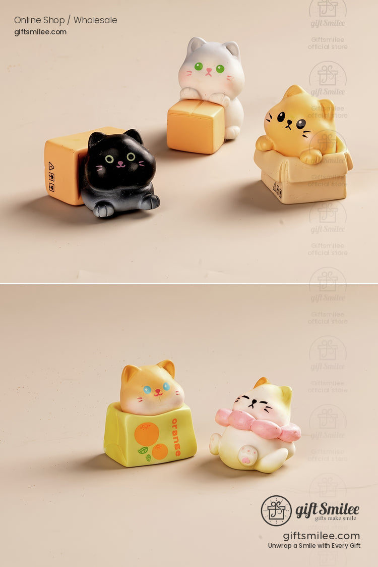 Set of ceramic cat figurines in black white and yellow sitting in mini boxes and cubes with playful expressions