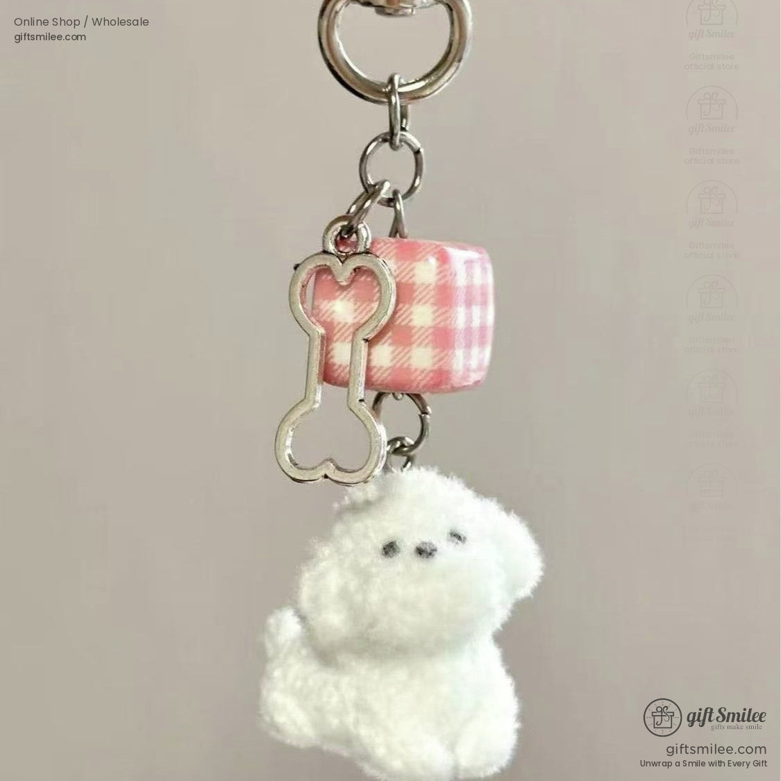 Fluffy white plush dog keychain with pink gingham cube and silver bone charm on a metal loop