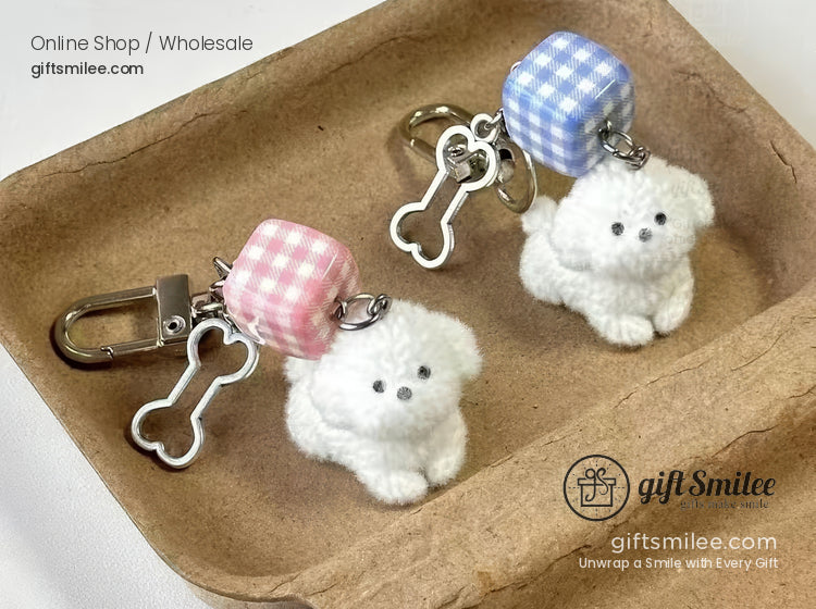 Fluffy white dog keychains with pink and blue gingham cubes silver bone charms and sturdy clasp attachments