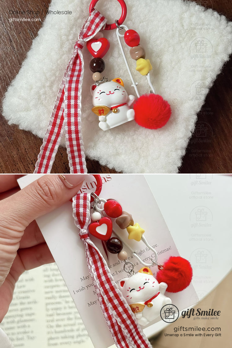 Lucky cat keychain with red pompom gingham ribbon heart and starshaped beads and vibrant charm accents