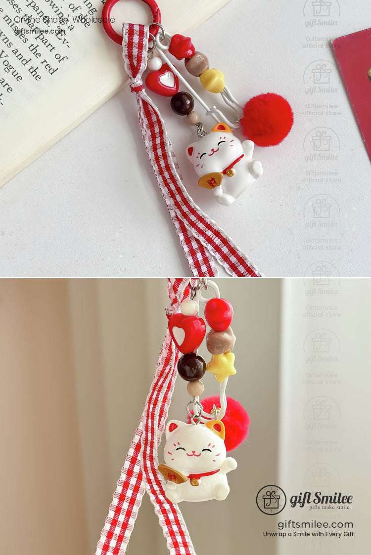 Red and white gingham ribbon keychain with lucky cat charm red pompom heart beads and yellow star accents