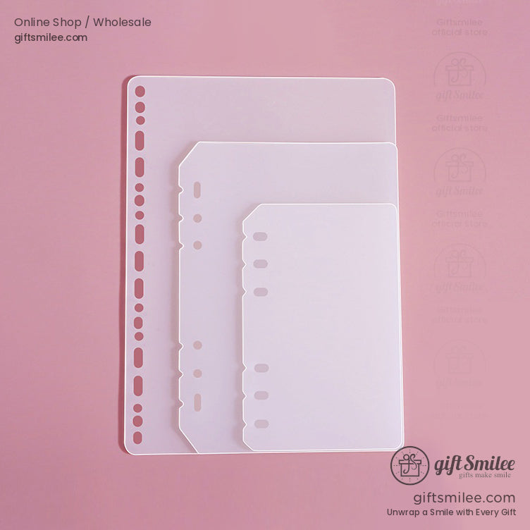 Transparent frosted plastic binder dividers in three sizes with prepunched holes on a pink background