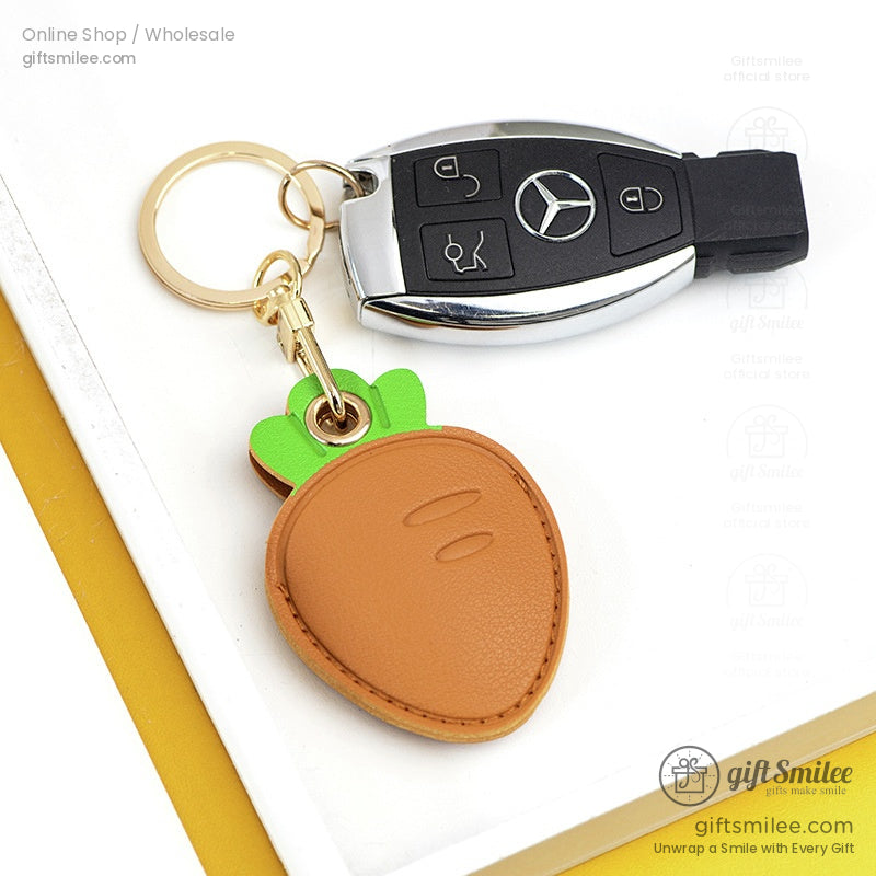 Green and beige crocodileshaped leather key fobs with gold key rings accented with playful embossed details