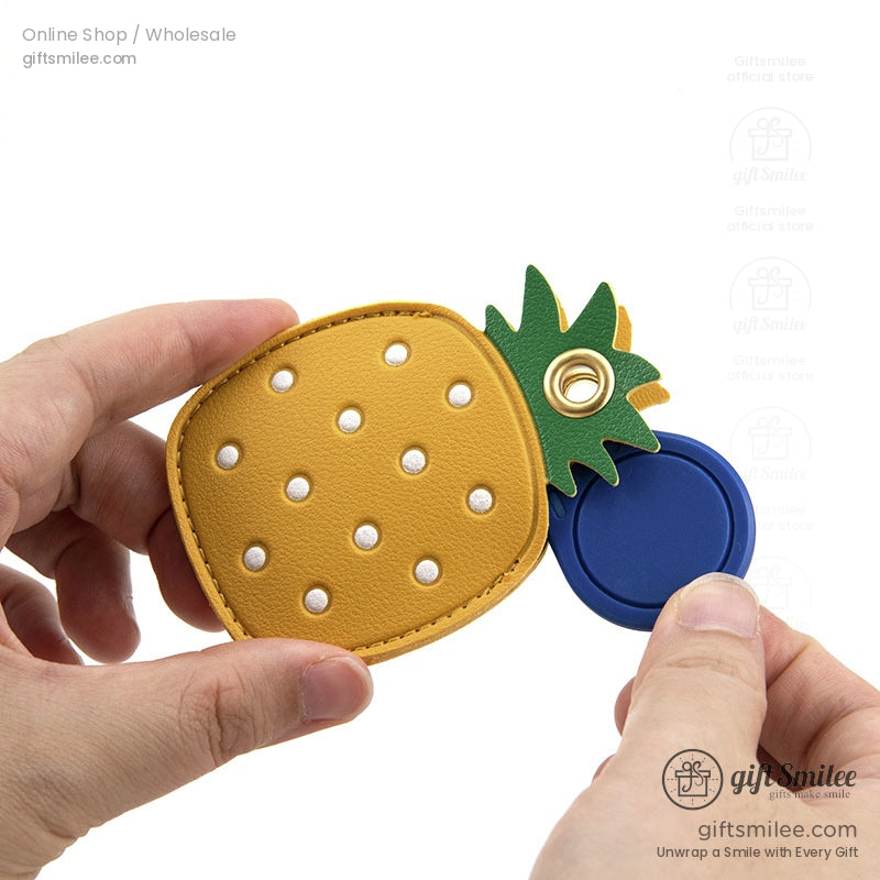 Yellow faux leather pineapple coin purse with green leafy top pearllike studs and a blue retractable lid