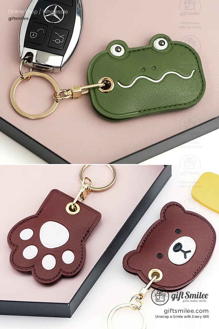 Green leather frogshaped keychain and brown leather animalthemed keychains with paw and bear designs