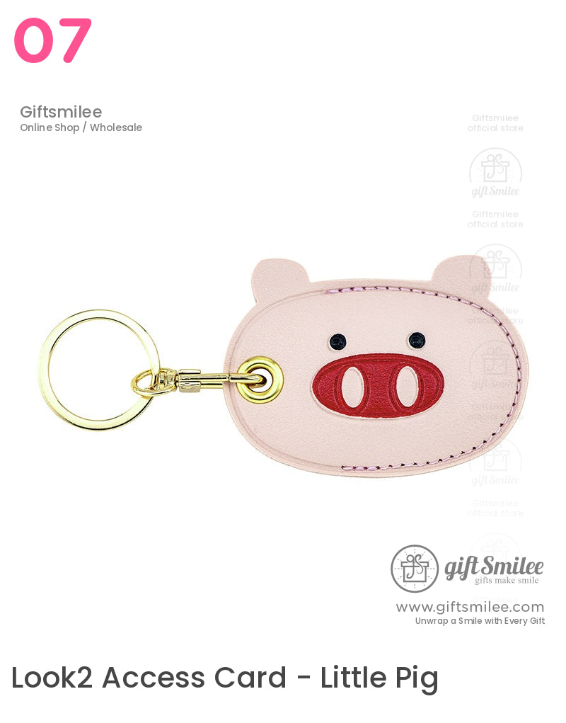 Pink leather pigshaped keychain with red snout detail black eyes goldtone metal ring and sturdy stitching