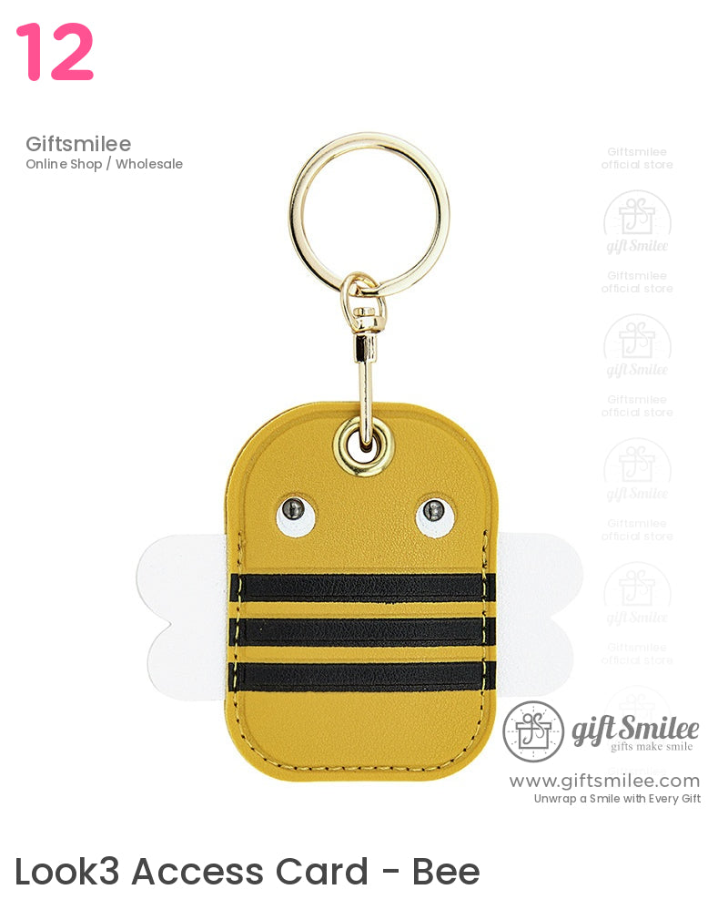 Yellow faux leather beeshaped keychain with black stripes white wings silver eye rivets and a gold metal ring