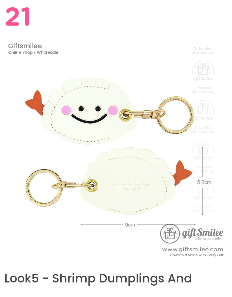 Smiling white dumplingshaped keychain with pink cheeks orange tail and gold metal ring measuring 9x53 cm