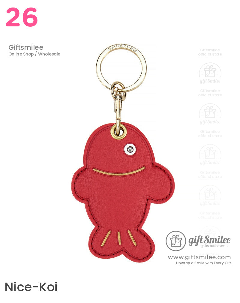 Red leather fishshaped keychain with gold stitching a single silver eye and a polished goldtone metal keyring